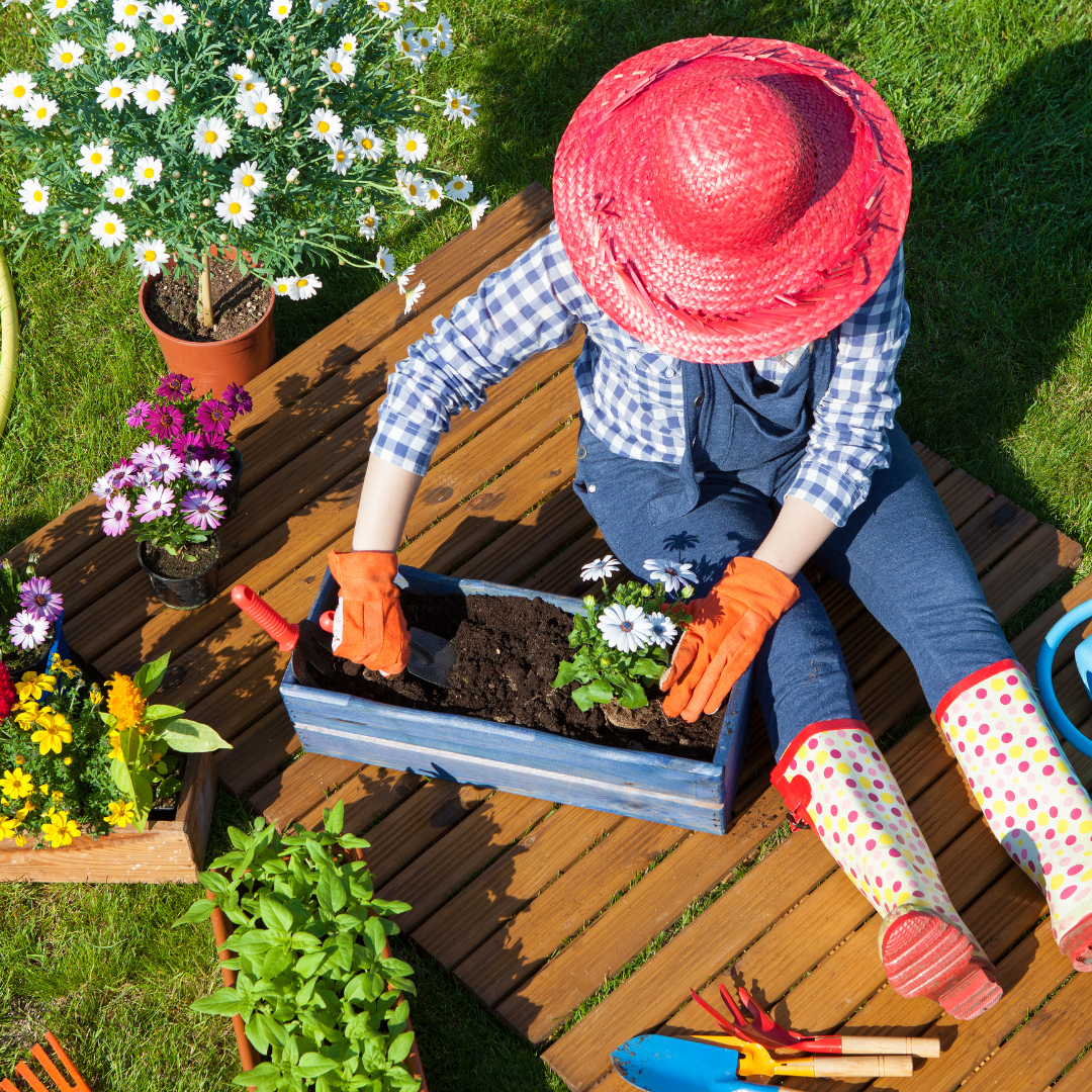 Lady working in garden with colorful hat